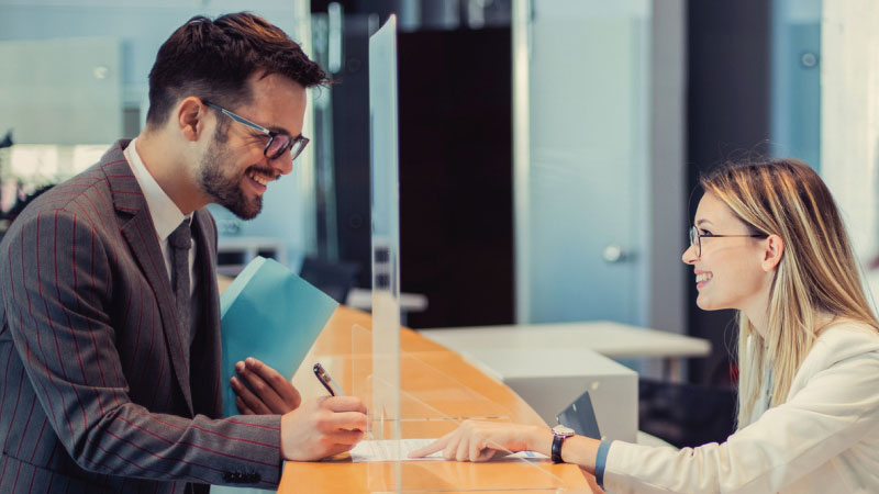 Person speaks with bank teller to get accounts in check